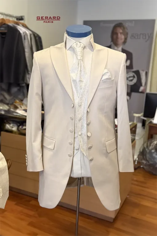 Santiago Beige Color wedding suit with frock coat, open front design, floral-patterned vest, and cravat-style tie
